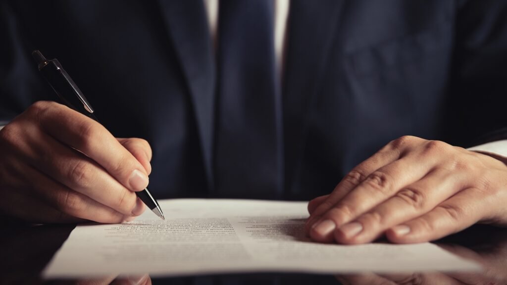 homem assina contrato